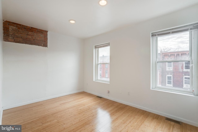 empty room with light hardwood / wood-style flooring