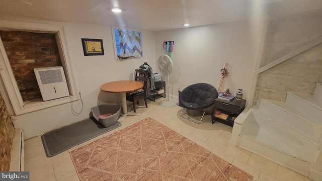 miscellaneous room with heating unit, tile patterned floors, and a baseboard heating unit