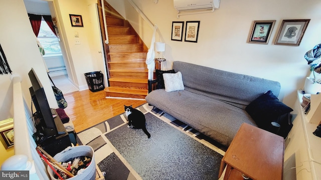 living room with a wall unit AC and wood-type flooring