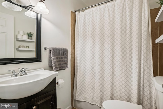 bathroom featuring toilet and vanity