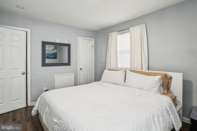 bedroom featuring dark wood-type flooring