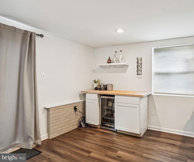 bar with white cabinets, dark hardwood / wood-style flooring, beverage cooler, and wood counters