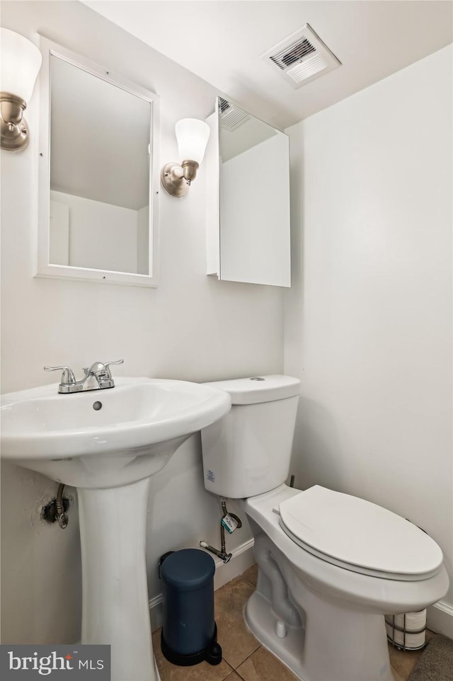 bathroom with tile patterned flooring and toilet