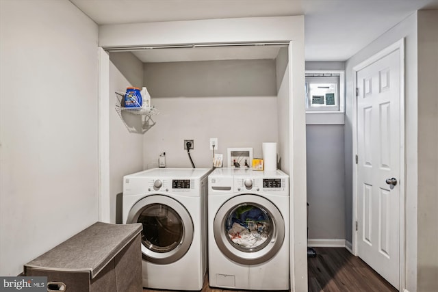 laundry room with dark wood-type flooring and washer and dryer