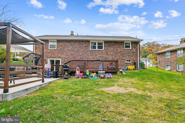 back of house featuring a deck and a yard