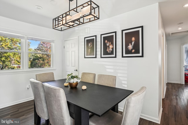 dining area featuring dark wood-type flooring