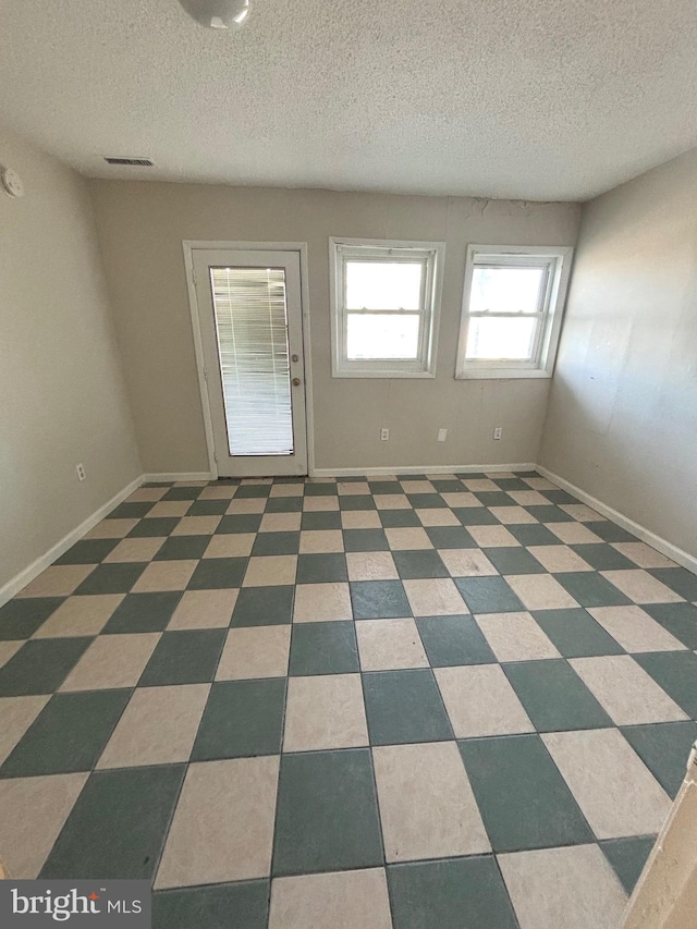 empty room with a textured ceiling