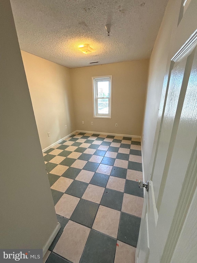 empty room featuring a textured ceiling