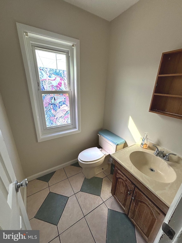 bathroom with vanity, toilet, and tile patterned flooring