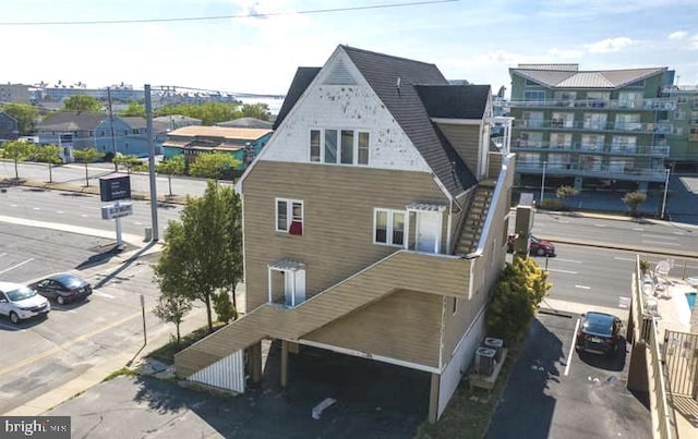 rear view of property featuring central air condition unit