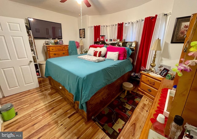 bedroom with light hardwood / wood-style floors and ceiling fan