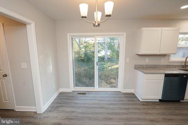 unfurnished dining area featuring sink, dark hardwood / wood-style floors, and plenty of natural light