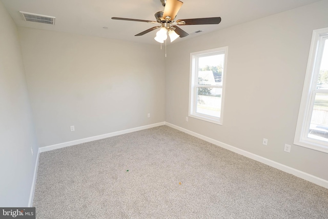 carpeted empty room featuring ceiling fan