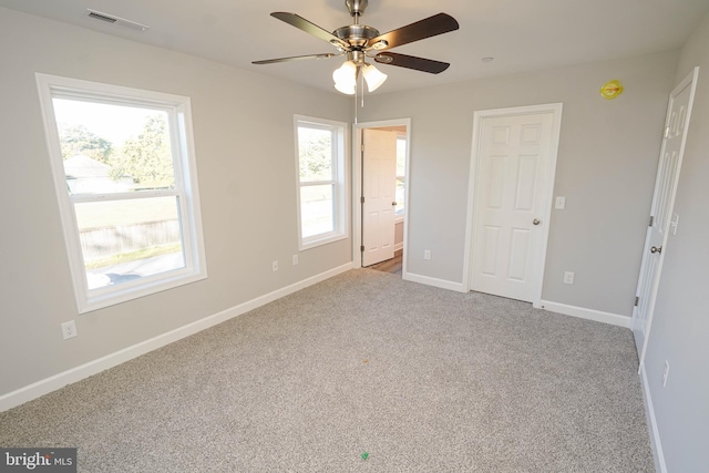 unfurnished bedroom featuring light colored carpet and ceiling fan