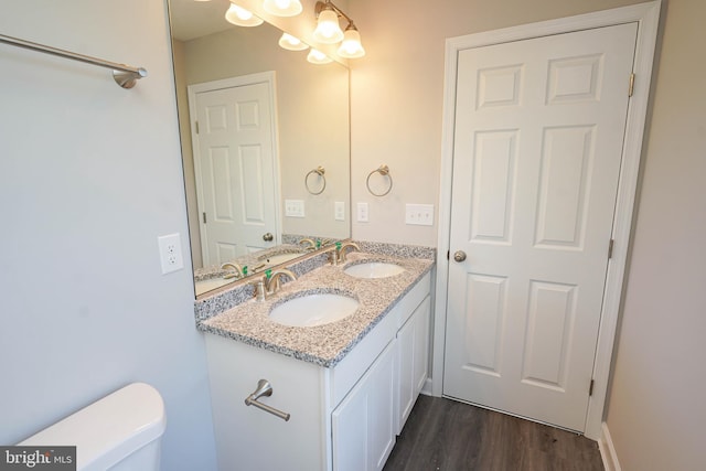 bathroom with vanity, hardwood / wood-style flooring, and toilet