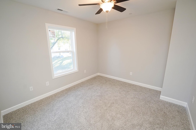 carpeted spare room featuring ceiling fan