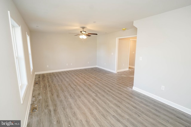 unfurnished room featuring light hardwood / wood-style floors and ceiling fan