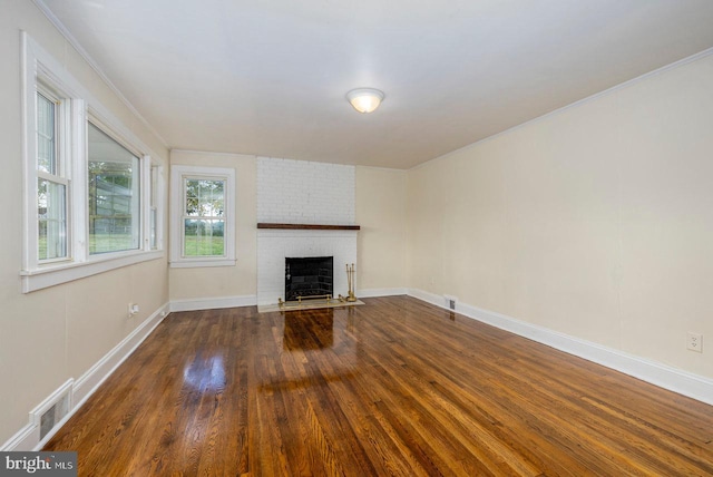 unfurnished living room with a fireplace, dark hardwood / wood-style flooring, and ornamental molding