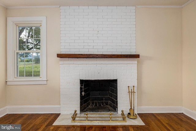 details with hardwood / wood-style flooring, ornamental molding, and a brick fireplace