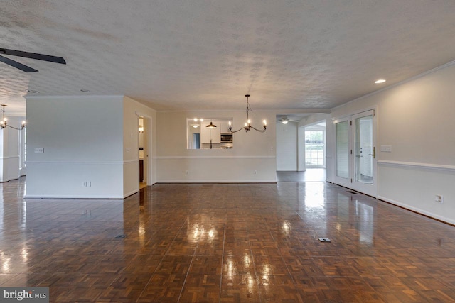 unfurnished living room with a textured ceiling, french doors, ceiling fan with notable chandelier, and ornamental molding