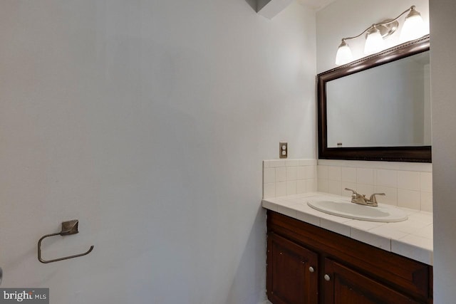 bathroom with decorative backsplash and vanity