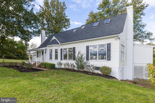 rear view of property featuring a yard