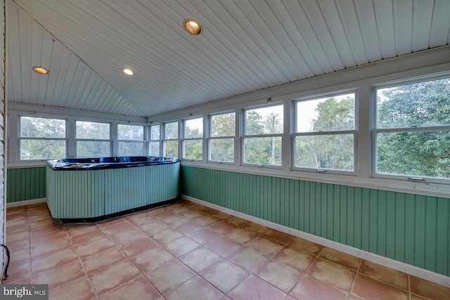 unfurnished sunroom with a hot tub, lofted ceiling, and wood ceiling