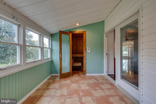 unfurnished sunroom featuring wood ceiling and lofted ceiling