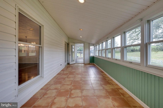 unfurnished sunroom with vaulted ceiling and wood ceiling