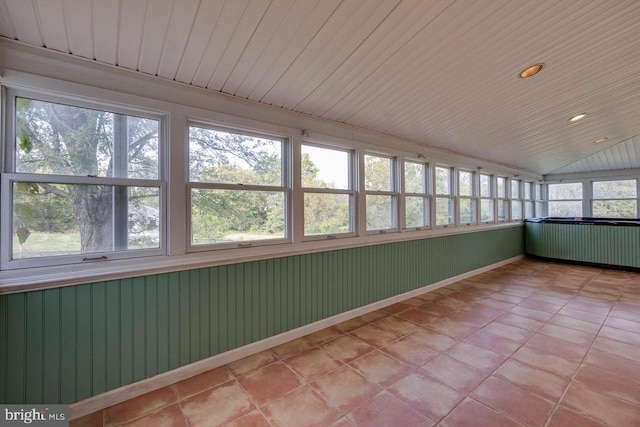 unfurnished sunroom with radiator, wooden ceiling, and vaulted ceiling