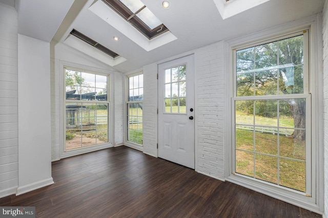 doorway with dark hardwood / wood-style flooring and vaulted ceiling