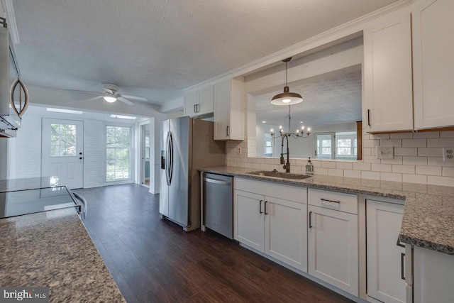 kitchen featuring white cabinetry, sink, stainless steel appliances, dark hardwood / wood-style flooring, and ceiling fan with notable chandelier