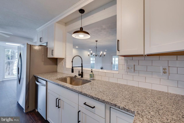 kitchen featuring dishwasher, sink, light stone counters, dark hardwood / wood-style flooring, and white cabinetry