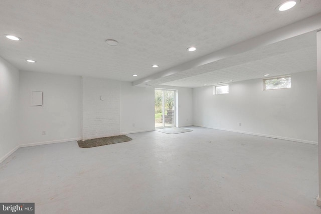 basement featuring a textured ceiling