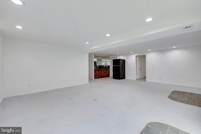 unfurnished living room with concrete flooring