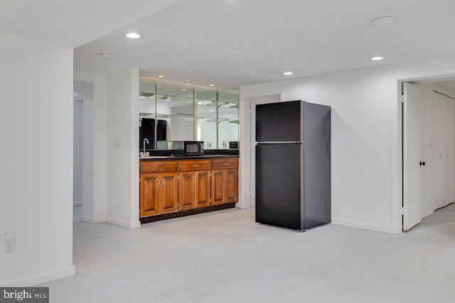 kitchen featuring stainless steel fridge and sink