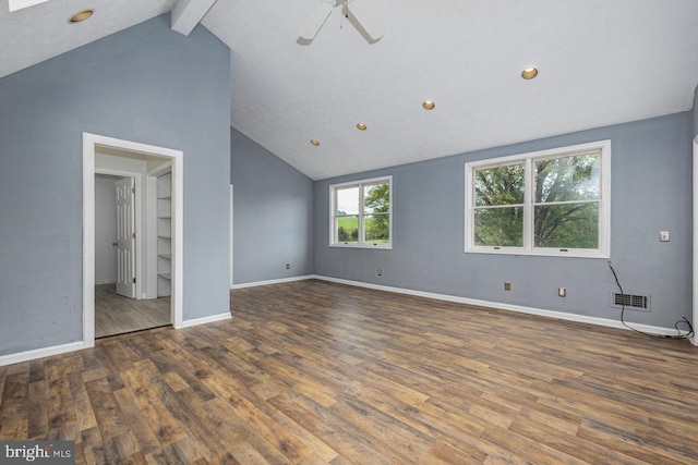 unfurnished bedroom with dark hardwood / wood-style floors, lofted ceiling with beams, and ceiling fan