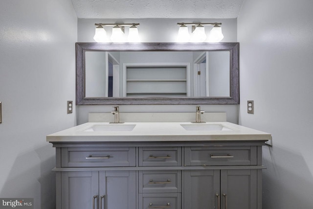 bathroom with vanity and a textured ceiling