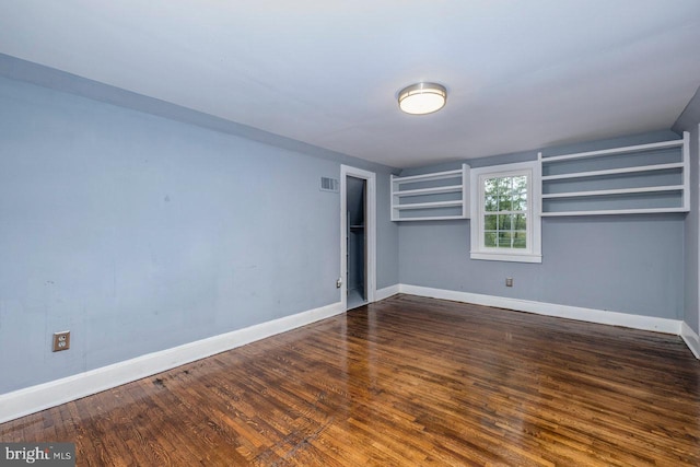 unfurnished bedroom with dark hardwood / wood-style floors