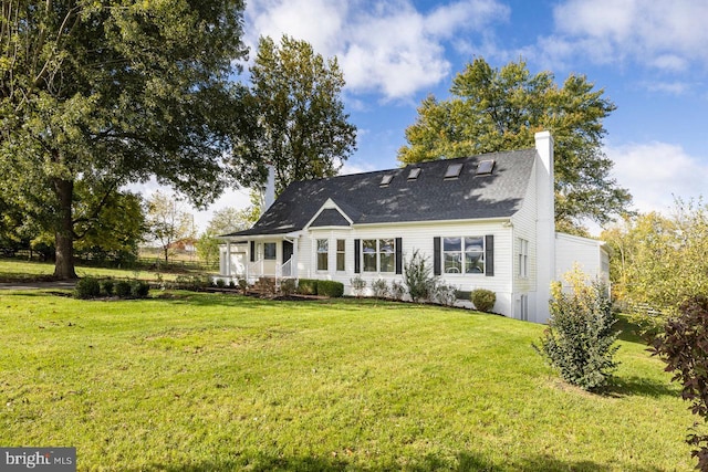 rear view of house featuring a yard