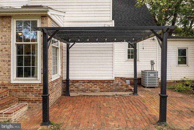 view of side of property with a pergola and central AC