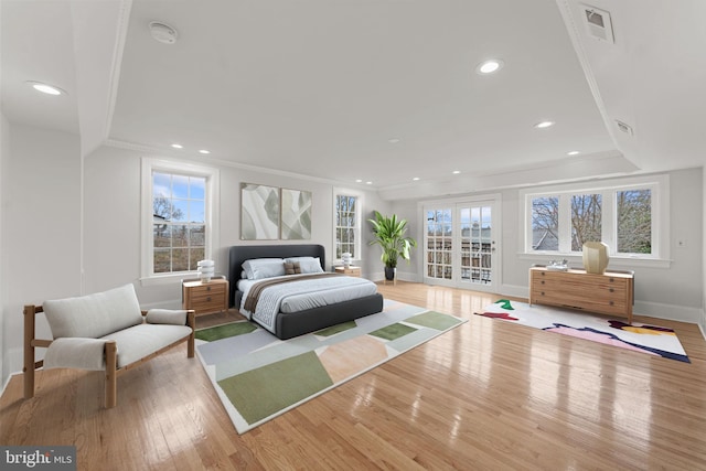 bedroom featuring multiple windows, crown molding, access to exterior, and light hardwood / wood-style flooring