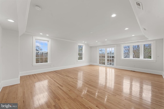 unfurnished living room featuring light hardwood / wood-style flooring and ornamental molding