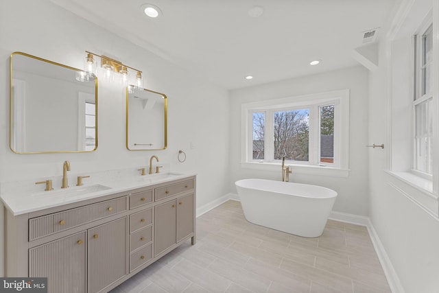 bathroom with vanity and a washtub