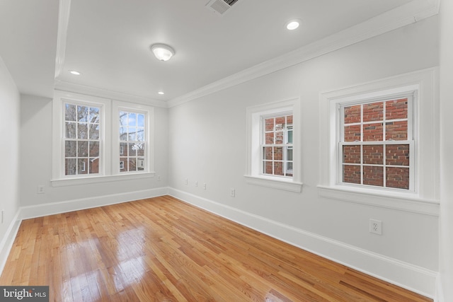 empty room featuring ornamental molding and wood-type flooring