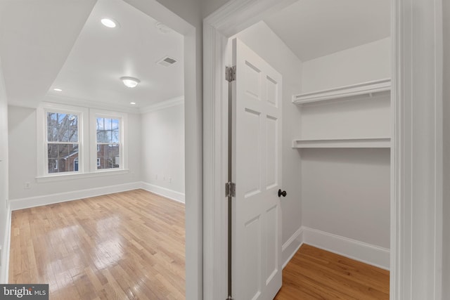 hallway with hardwood / wood-style flooring