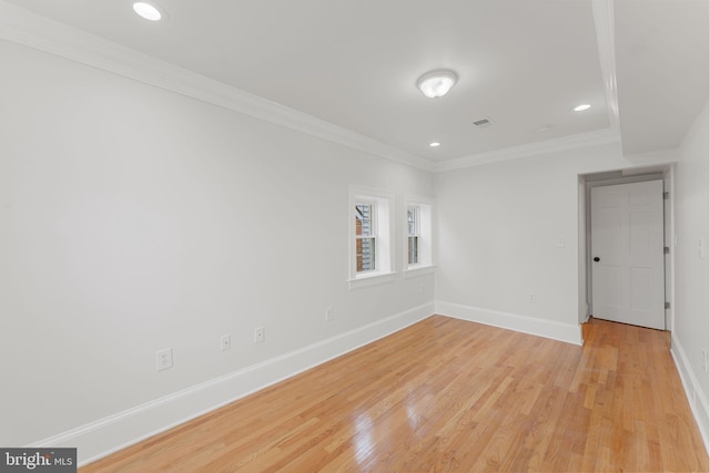 unfurnished room with crown molding and light hardwood / wood-style floors