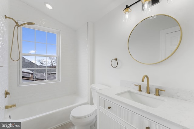 full bathroom with lofted ceiling, toilet, tiled shower / bath combo, and vanity