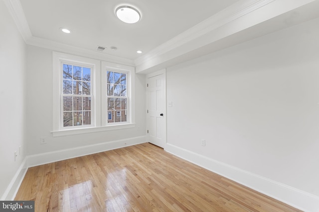 unfurnished room featuring hardwood / wood-style flooring and crown molding