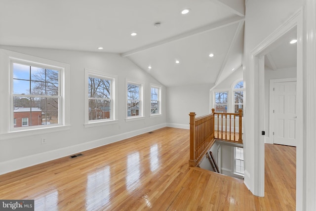 bonus room featuring vaulted ceiling with beams and light hardwood / wood-style floors